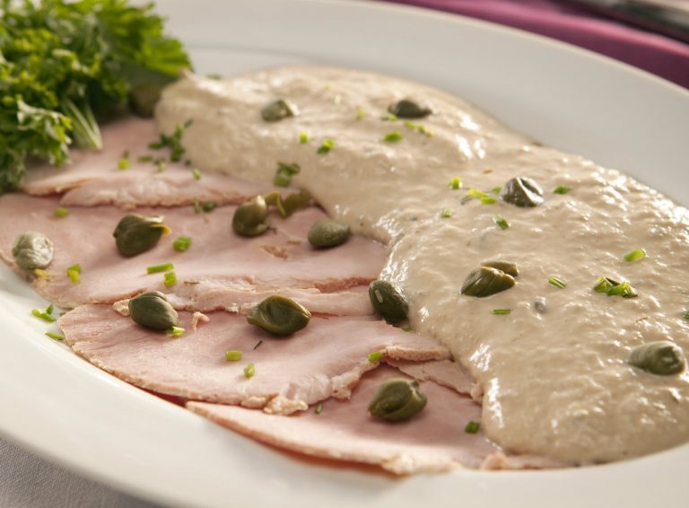 Sliced veal covered in creamy tuna sauce with capers and chives