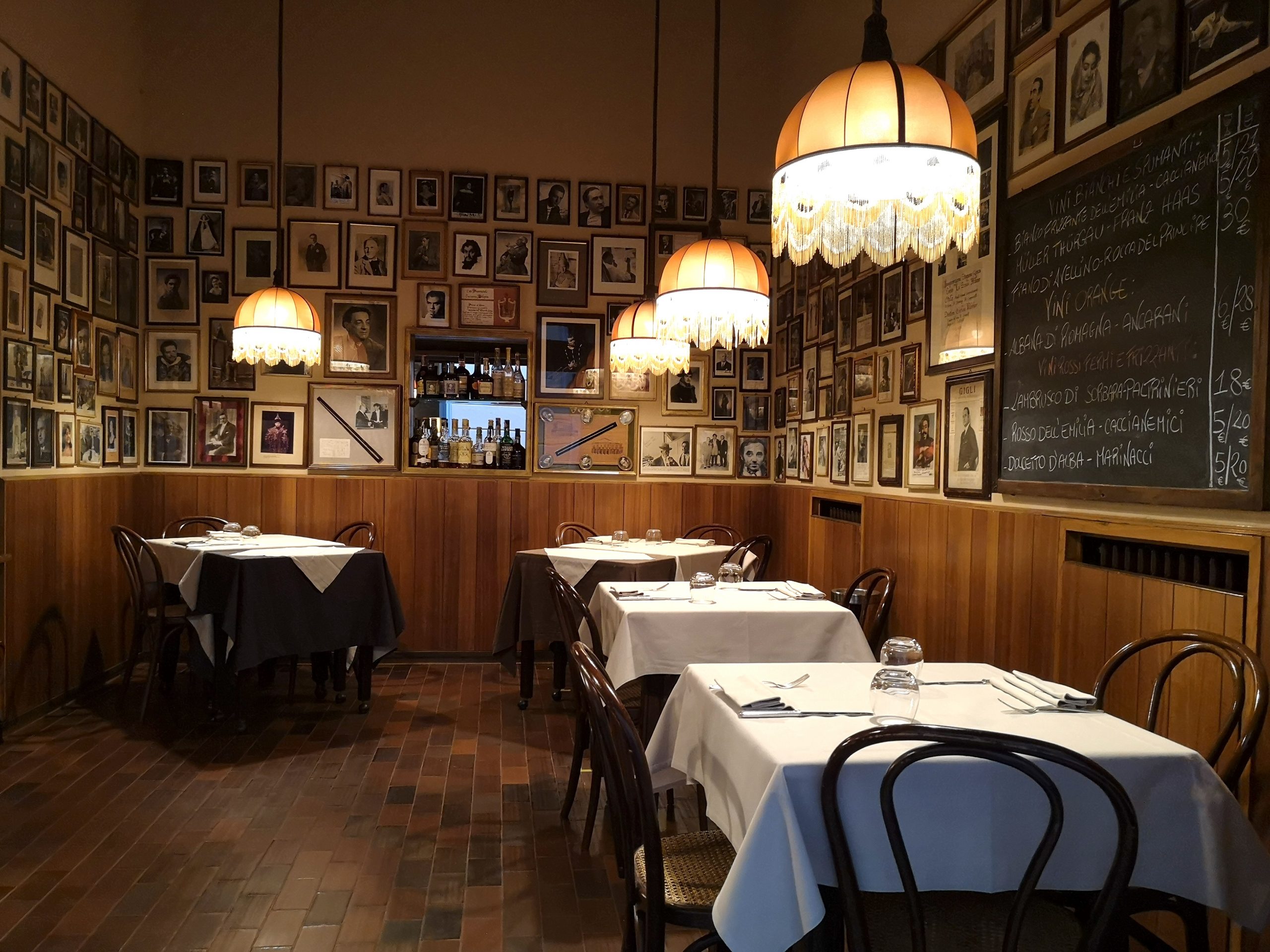 Sala di un ristorante con pareti coperte di foto incorniciate